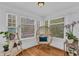 Cozy sunroom with a cushioned papasan chair, perfect for relaxation and reading at 1901 10Th St, St Cloud, FL 34769