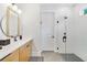 Bright bathroom featuring a modern vanity, framed round mirror, and a glass-enclosed walk-in shower at 2110 Hillcrest St, Orlando, FL 32803