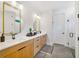 Modern bathroom featuring double sink vanity, gold framed mirrors, and glass shower at 2110 Hillcrest St, Orlando, FL 32803