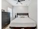 Well-lit bedroom with a padded headboard bed frame, dresser, and a ceiling fan at 2110 Hillcrest St, Orlando, FL 32803
