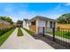 Charming home featuring a long driveway, fenced yard, and a partially covered outdoor patio at 2110 Hillcrest St, Orlando, FL 32803