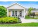 Charming single-story home boasts a well-manicured front yard with lush landscaping and a welcoming front porch at 2110 Hillcrest St, Orlando, FL 32803