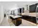 Open-concept kitchen with sleek, dark cabinetry, a central island, and modern pendant lighting at 2110 Hillcrest St, Orlando, FL 32803