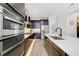 A kitchen featuring modern appliances, an island with seating, and stylish lighting under the cabinets at 2110 Hillcrest St, Orlando, FL 32803