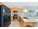 Modern kitchen featuring wood cabinetry, stainless steel appliances, and quartz countertops at 2110 Hillcrest St, Orlando, FL 32803