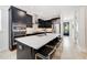 Modern kitchen features stainless steel appliances, a large island with bar seating, and stylish countertops at 2110 Hillcrest St, Orlando, FL 32803