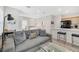 Open-concept living space with a comfortable sofa, modern decor, and partial view of kitchen at 2110 Hillcrest St, Orlando, FL 32803