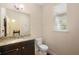 Half-bathroom featuring granite countertop and dark wood cabinets at 2136 J Lawson Blvd, Orlando, FL 32824