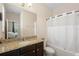 Full bathroom features granite countertop, dark wood cabinets, and shower with white shower curtain at 2136 J Lawson Blvd, Orlando, FL 32824
