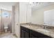 Well-lit bathroom with double vanity, granite countertops, and access to the toilet and shower area at 2136 J Lawson Blvd, Orlando, FL 32824