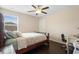 This bedroom features a ceiling fan, wood floors, and space for a desk or dresser at 2136 J Lawson Blvd, Orlando, FL 32824