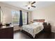 Comfortable bedroom with a ceiling fan, large windows, and dresser at 2136 J Lawson Blvd, Orlando, FL 32824