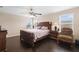 This bedroom features a ceiling fan, hard wood floors, 2 windows, and space for a sitting area at 2136 J Lawson Blvd, Orlando, FL 32824