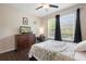 Relaxing bedroom with a ceiling fan, large windows, and dresser at 2136 J Lawson Blvd, Orlando, FL 32824