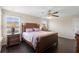 This bedroom features a ceiling fan, wood floors, 2 windows, and space for a desk or dresser at 2136 J Lawson Blvd, Orlando, FL 32824