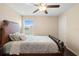 Cozy bedroom featuring a ceiling fan and natural light from the window at 2136 J Lawson Blvd, Orlando, FL 32824