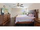 This bedroom features a ceiling fan, hard wood floors, a TV, and space for a desk or dresser at 2136 J Lawson Blvd, Orlando, FL 32824