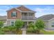 Exterior elevation of a two-story home with balcony and landscaped yard at 2136 J Lawson Blvd, Orlando, FL 32824