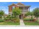 Charming two-story home with a cozy front porch and meticulously landscaped yard at 2136 J Lawson Blvd, Orlando, FL 32824