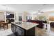 Open concept kitchen with island seating and view to living room and dining area at 2136 J Lawson Blvd, Orlando, FL 32824