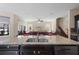 Bright kitchen with granite counters, stainless appliances, and view to living room and staircase at 2136 J Lawson Blvd, Orlando, FL 32824