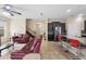 Bright living room with tile flooring, access to the kitchen bar, and a view of the staircase at 2136 J Lawson Blvd, Orlando, FL 32824