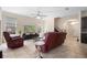 Comfortable living room with large windows, ceiling fan and staircase at 2136 J Lawson Blvd, Orlando, FL 32824