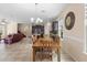 Open-concept living room and dining area with tile flooring, a chandelier, and a comfortable red couch at 2136 J Lawson Blvd, Orlando, FL 32824