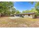 Spacious fenced backyard featuring a concrete patio and sunroom, perfect for outdoor entertaining and relaxation at 2312 Ne 32Nd Pl, Ocala, FL 34479
