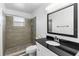 Updated bathroom with a tiled shower, glass door, and a granite-topped vanity at 2312 Ne 32Nd Pl, Ocala, FL 34479