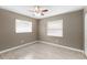 Cozy bedroom features wood-look tile flooring, and two windows letting in natural light at 2312 Ne 32Nd Pl, Ocala, FL 34479