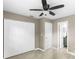Neutral bedroom features a ceiling fan, closet, and an ensuite bathroom view at 2312 Ne 32Nd Pl, Ocala, FL 34479