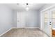 Bright dining area featuring wood-look tile floors, neutral paint, a ceiling fan, and access to the backyard at 2312 Ne 32Nd Pl, Ocala, FL 34479