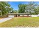 Charming single-story home with a well-manicured front yard and attached garage, perfect for suburban living at 2312 Ne 32Nd Pl, Ocala, FL 34479