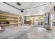 Spacious garage featuring a workbench, washer and dryer hookups, and built in shelving at 2312 Ne 32Nd Pl, Ocala, FL 34479