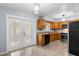 Well-lit kitchen with wooden cabinets, stainless steel appliances, and access to a bright dining area at 2312 Ne 32Nd Pl, Ocala, FL 34479