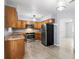 Well-lit kitchen with wooden cabinets, stainless steel appliances, and a neutral wall paint at 2312 Ne 32Nd Pl, Ocala, FL 34479