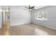 Bright living room featuring wood-look tile floors, neutral paint, and a view of a front window at 2312 Ne 32Nd Pl, Ocala, FL 34479