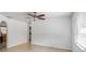 Bright living room featuring wood-look tile floors, neutral paint, a ceiling fan, and arched doorways at 2312 Ne 32Nd Pl, Ocala, FL 34479