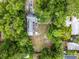 An overhead view of a tree covered backyard with a small patio set and small fire pit at 2312 Vivada St, Orlando, FL 32803