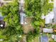 An overhead view of a tree covered backyard with a small patio set and small fire pit at 2312 Vivada St, Orlando, FL 32803