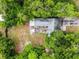 Aerial view of a home with a private backyard area, fire pit and mature trees at 2312 Vivada St, Orlando, FL 32803
