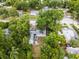 An overhead view of a tree covered backyard with a small patio set and small fire pit at 2312 Vivada St, Orlando, FL 32803