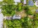 Aerial view of a private backyard featuring a fire pit and patio area surrounded by lush greenery at 2312 Vivada St, Orlando, FL 32803