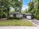 Charming single-story home with gray siding, inviting front porch, and a one-car garage at 2312 Vivada St, Orlando, FL 32803