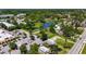 Aerial view of a residential area with a small pond, lush greenery, and ample parking at 233 E Church Ave, Longwood, FL 32750