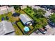 Aerial view of a charming home with a backyard umbrella, surrounded by lush greenery and parking at 233 E Church Ave, Longwood, FL 32750