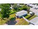 Aerial view of a charming home and backyard, surrounded by lush greenery and a parking lot at 233 E Church Ave, Longwood, FL 32750