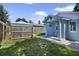 Fenced backyard featuring a grassy area and a relaxing space with shade for outdoor activities at 233 E Church Ave, Longwood, FL 32750