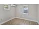 This cozy bedroom features natural light, and neutral paint at 233 E Church Ave, Longwood, FL 32750